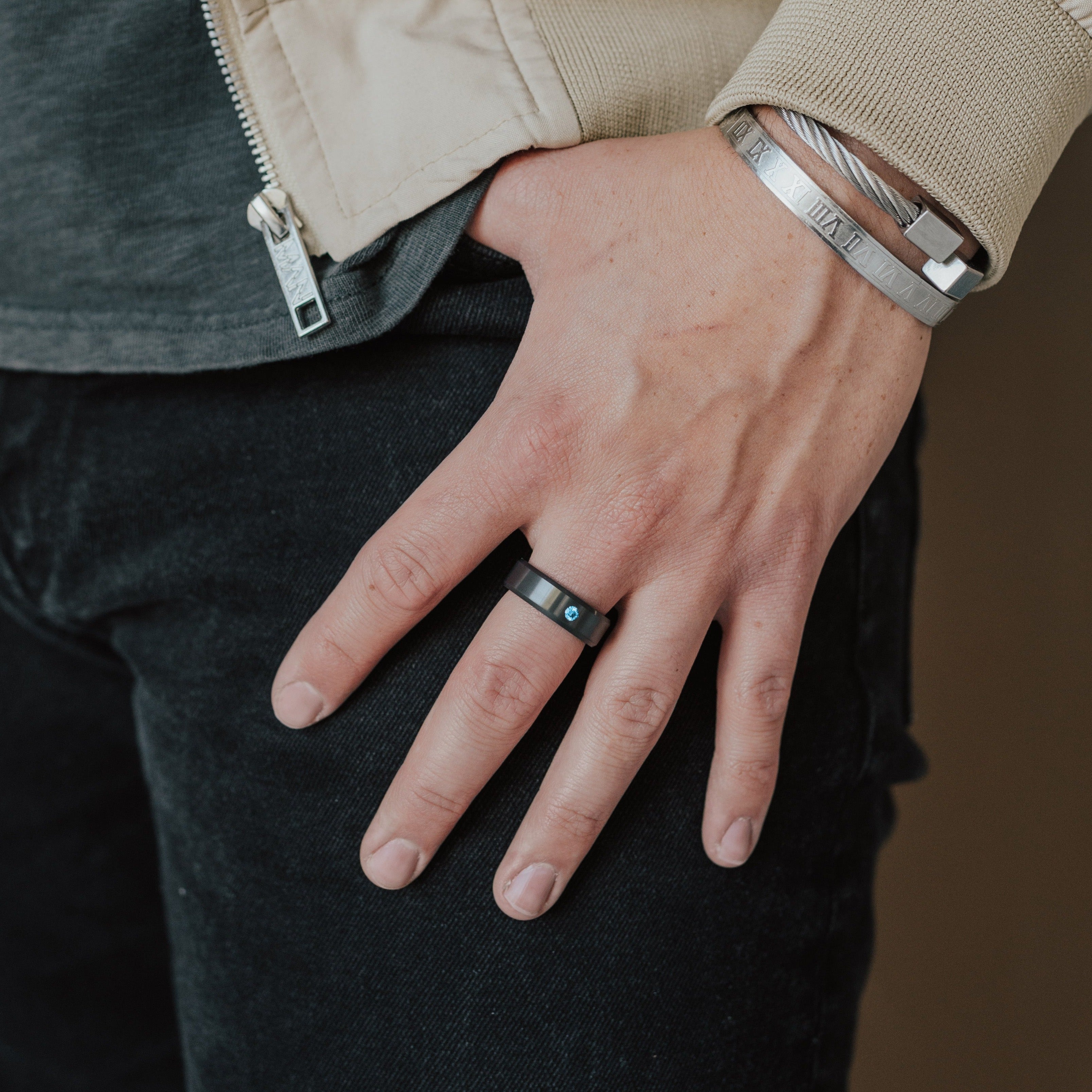 Lifestyle shot #2 of men's hands wearing our Elysium ARES Men's Black Diamond & Blue Diamond Inset | ElysiumBlack.com | Men’s Blue Diamond Wedding Rings