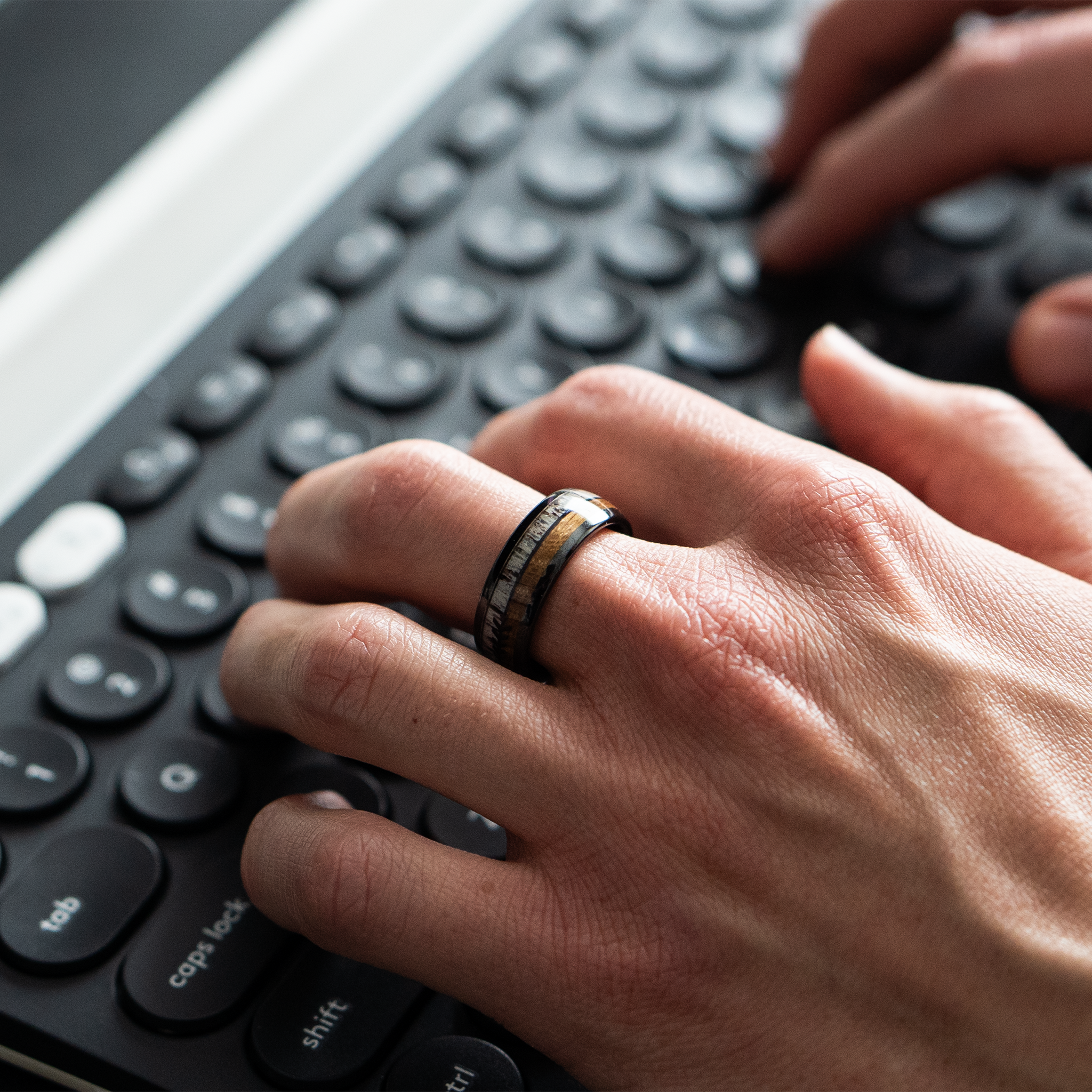Eros ring – polished Black Ceramic featuring Whiskey Barrel Wood, Deer Antler and Black Arrow Foil part of the Hustler Collection. Lifestyle Shot, On Hand