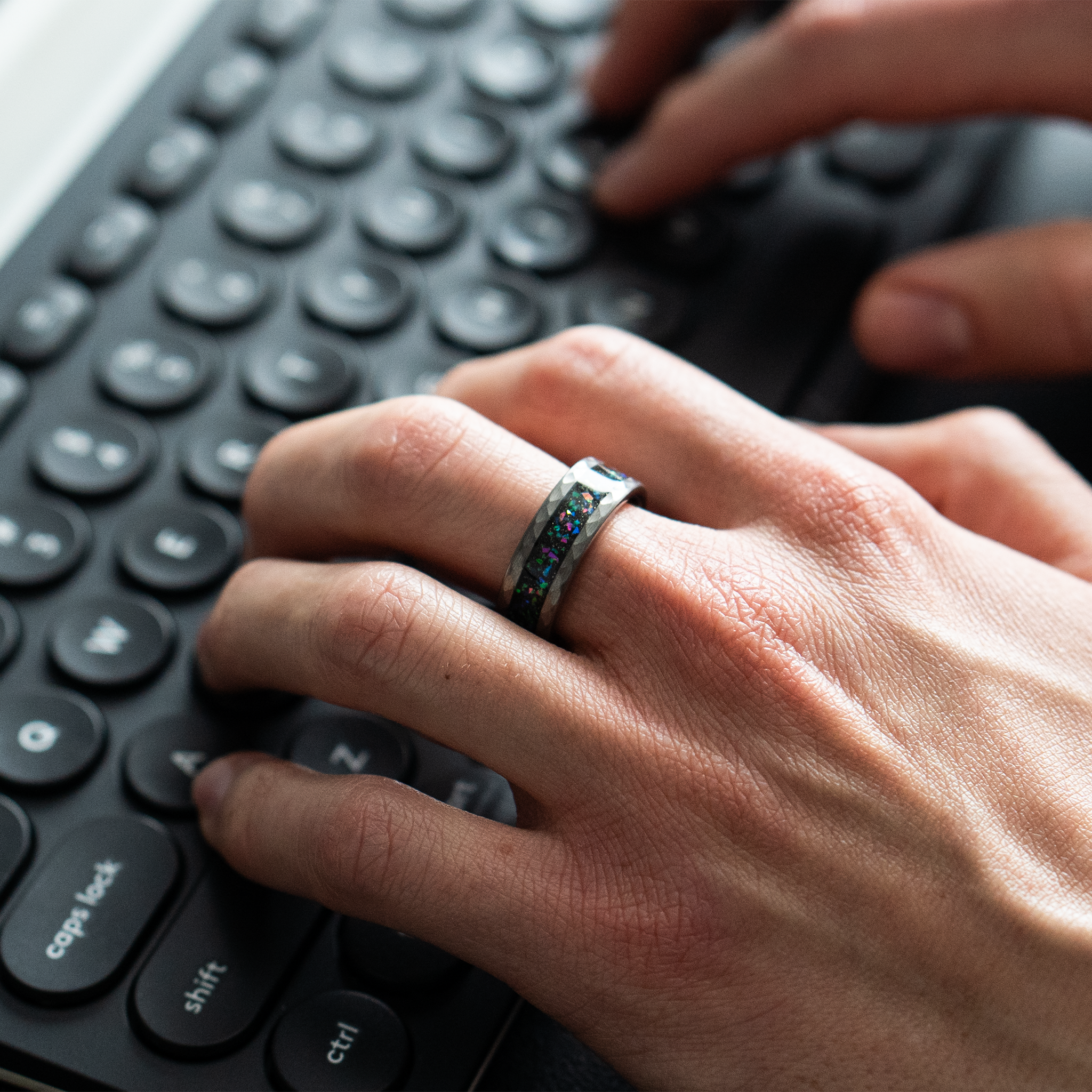 Typhon ring – Hammered Silver Tungsten featuring a Crushed Opal Inlay from the Hustler Collection. Lifestyle shot, on hand