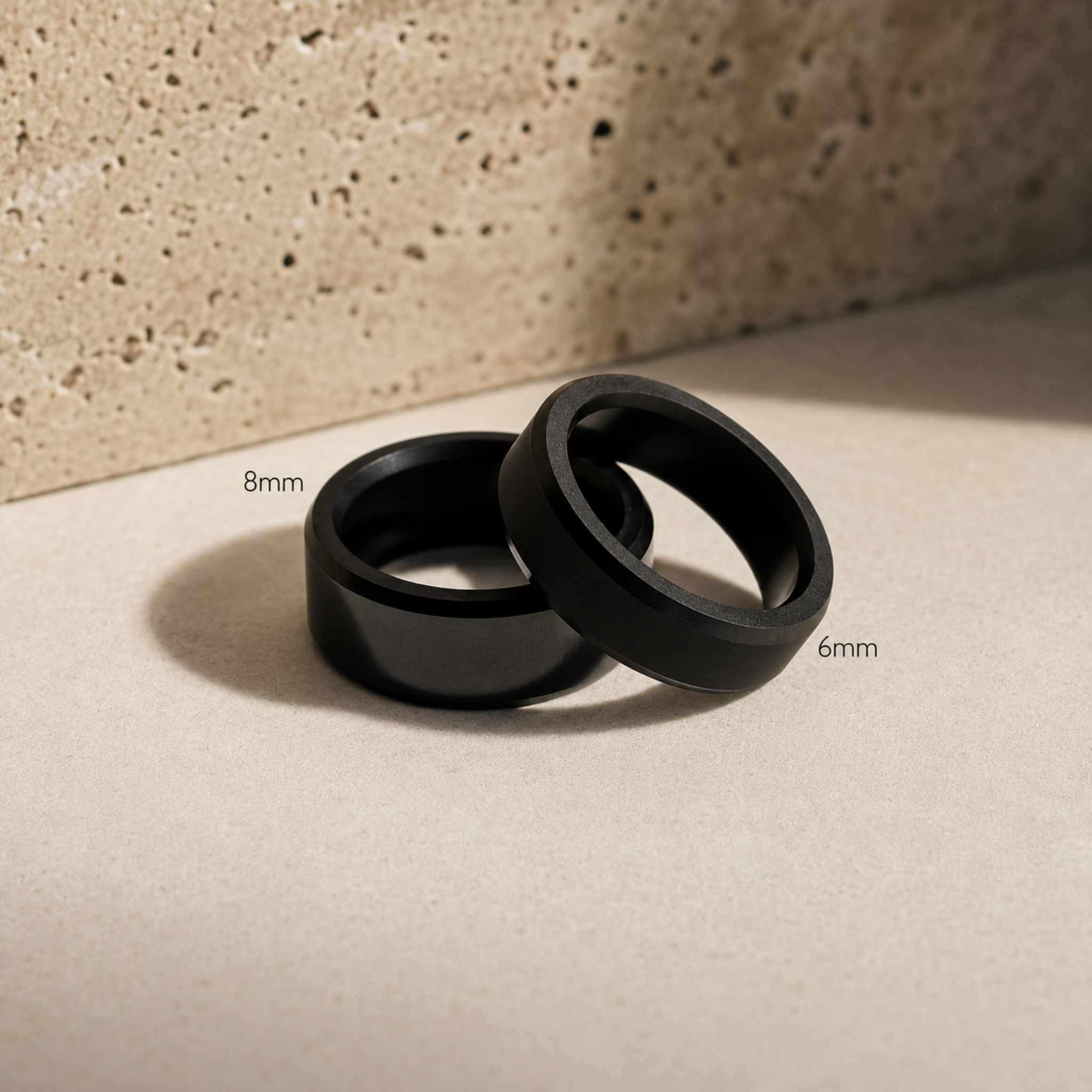 ARES solid black diamond wedding bands shown in 8mm and 6mm widths for size comparison