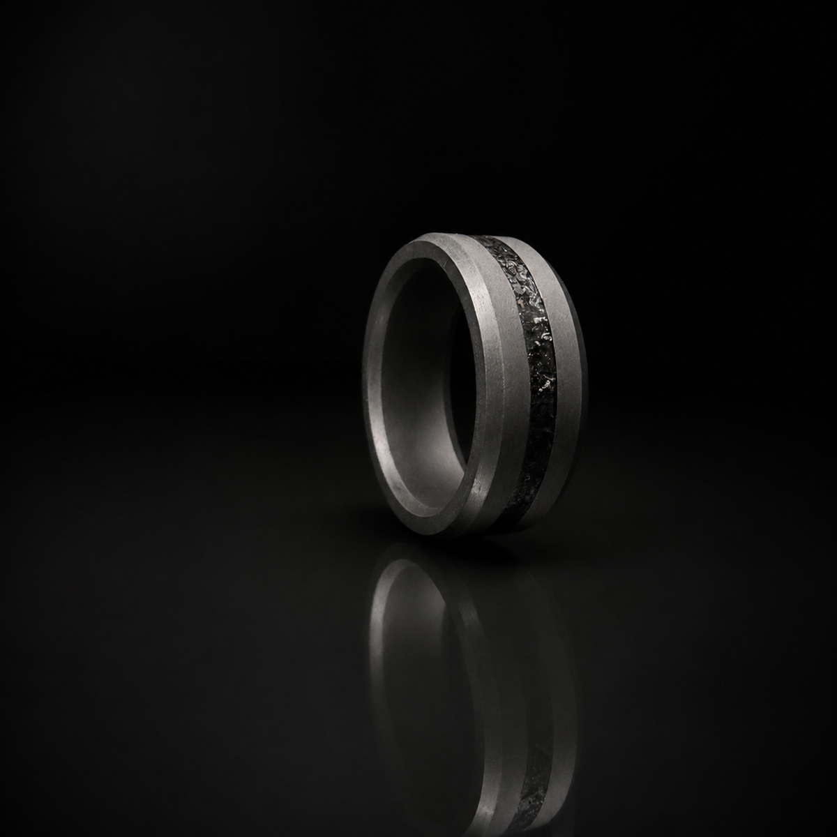 ARES obsidian inlay ring in solid black diamond on dark editorial surface