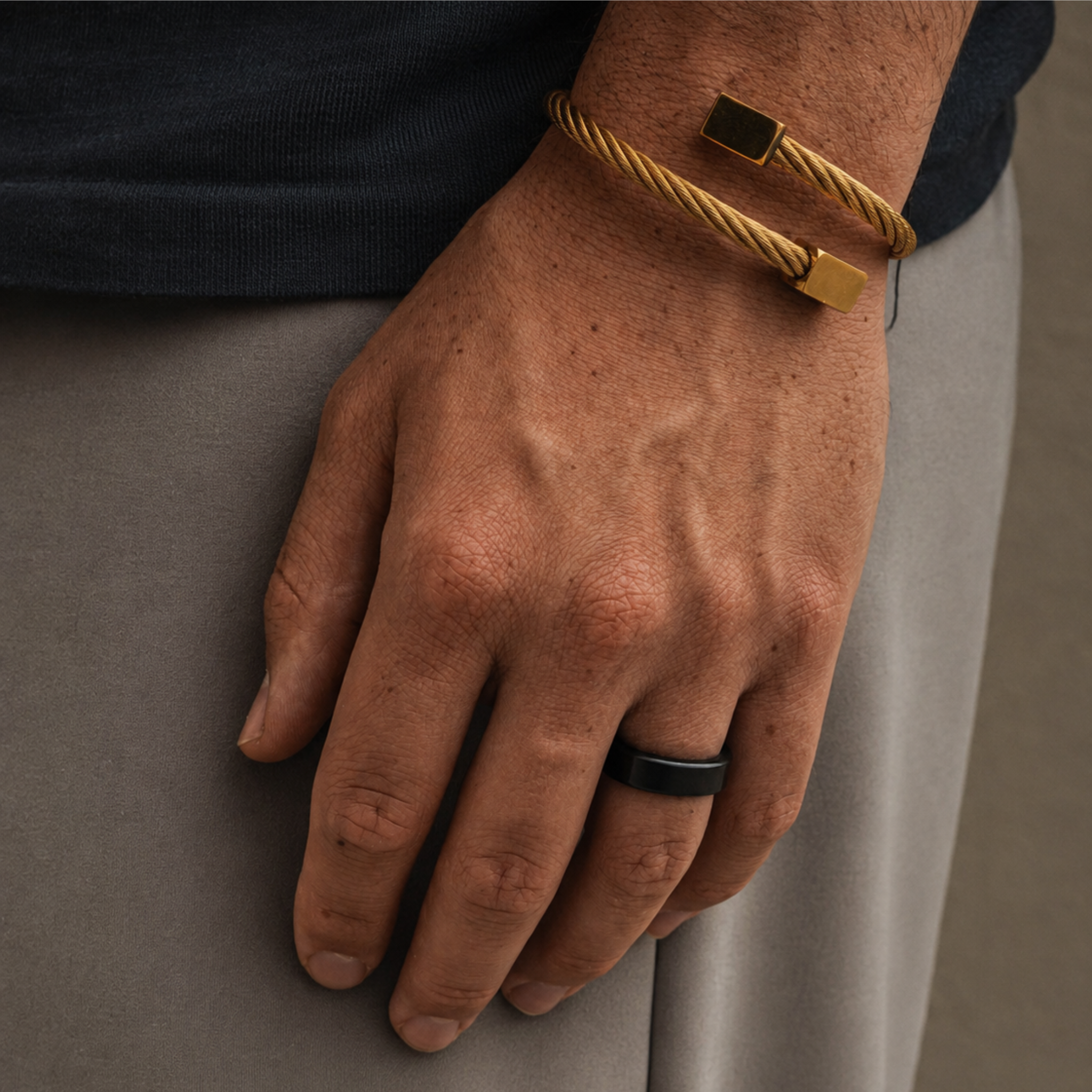 KRATOS 6mm polished solid black diamond wedding band worn on a resting hand