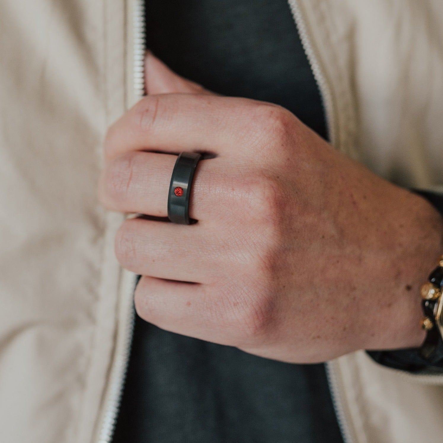 Lifestyle shot #1 of men's hands wearing our Elysium ARES Men's Black Diamond & Red Diamond Inset | ElysiumBlack.com | Men’s Red Diamond Wedding Rings