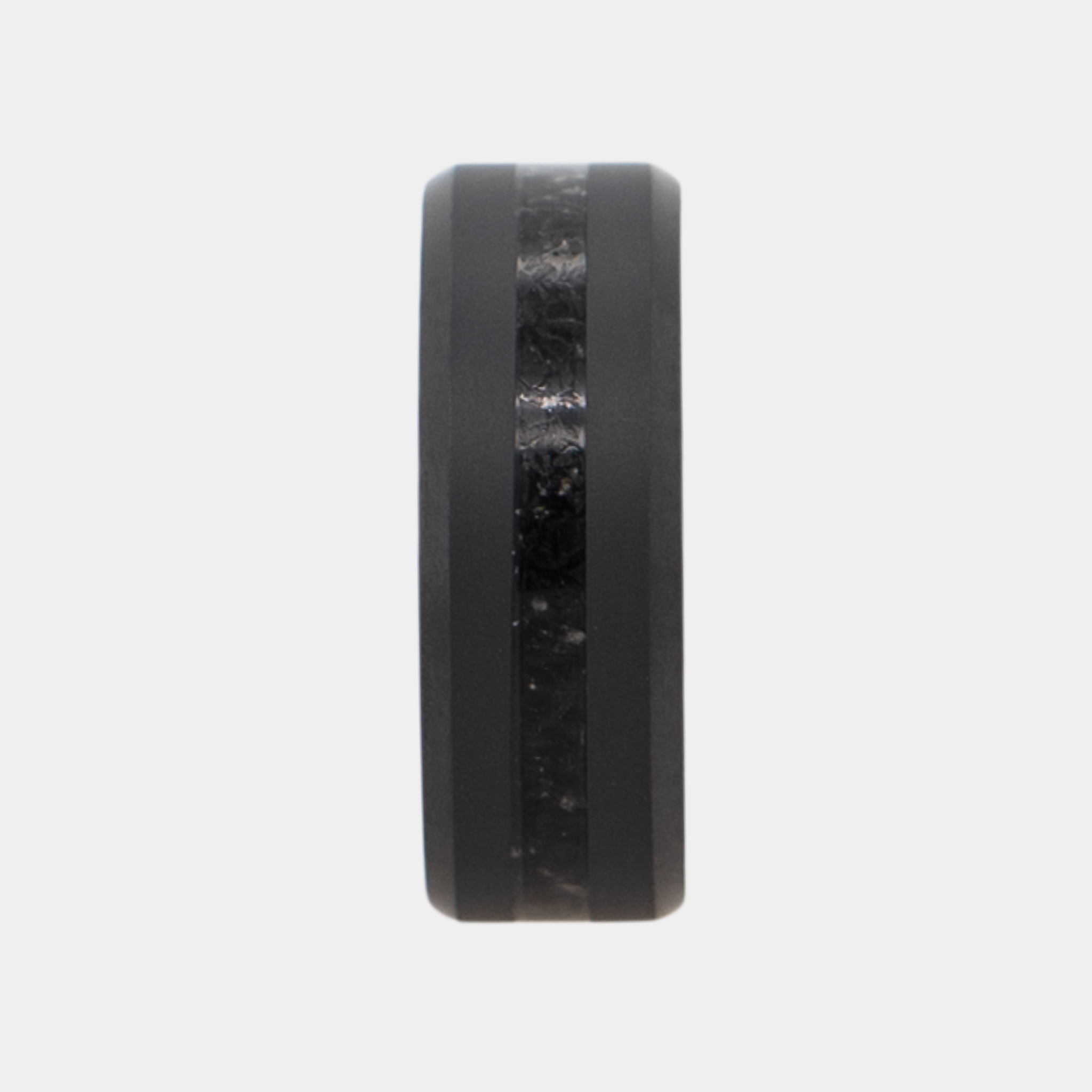 Vertical view of Solid Black Diamond ring with obsidian inlay on a light gray background