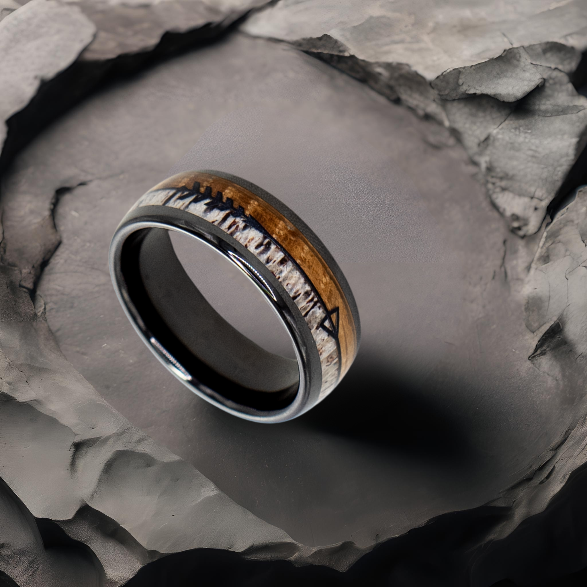 Eros ring – solid black diamond with polished beveled edges from the Hustler Collection. Lifestyle shot, placed on textured fabric.